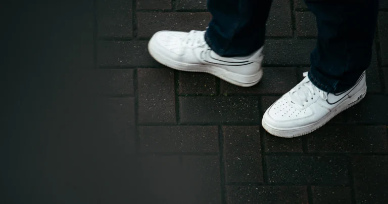 Person in white sneakers walking on a brick path, earning rewards with apps that pay you to walk