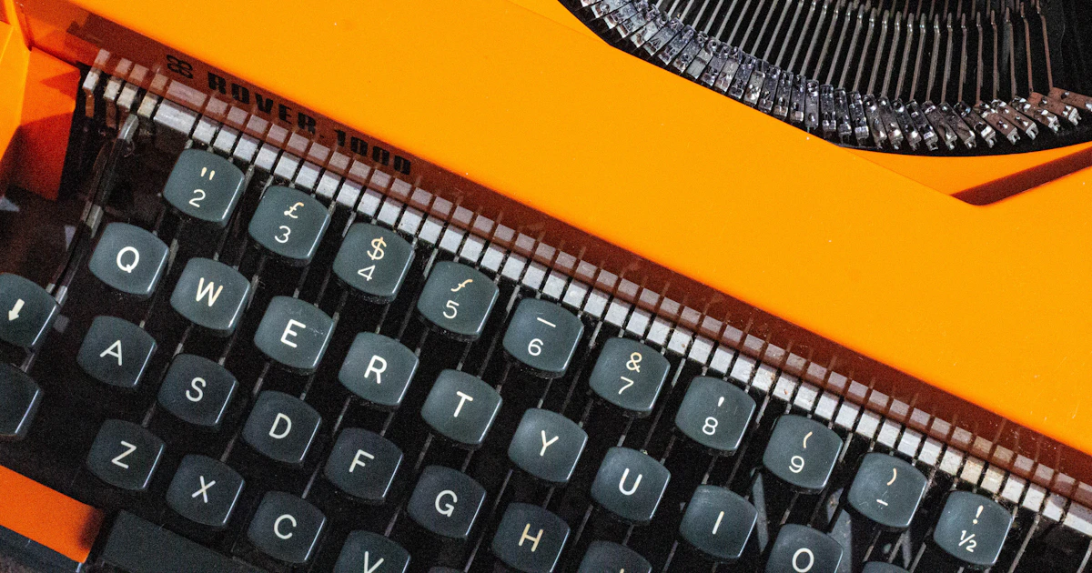 Close-up of a bright orange typewriter, representing the best AI writing tools
