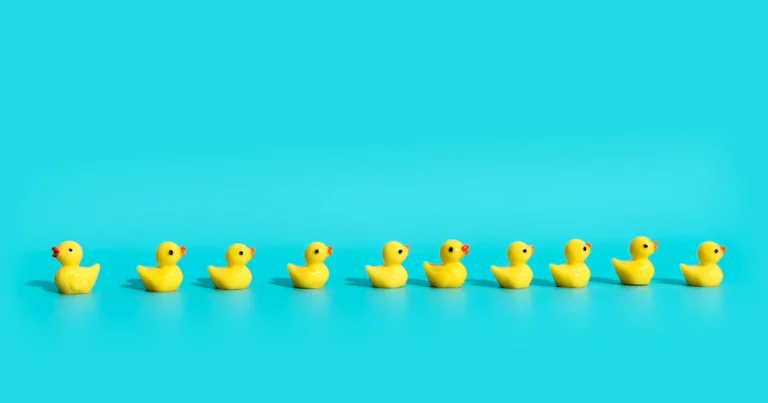 Identical rubber ducks in a row, like fake X followers