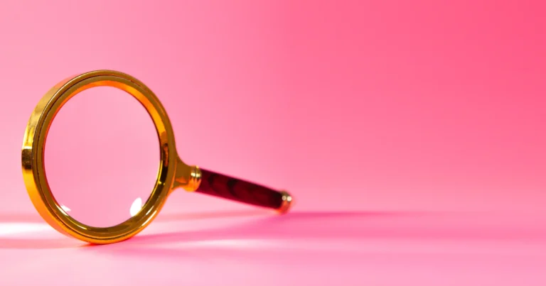 Magnifying glass on a pink background representing free website usability testing