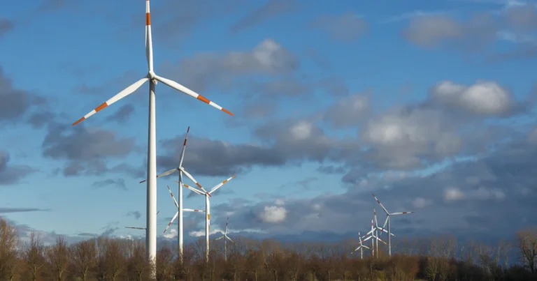 Google data center energy: wind turbine on green grass under a blue sky