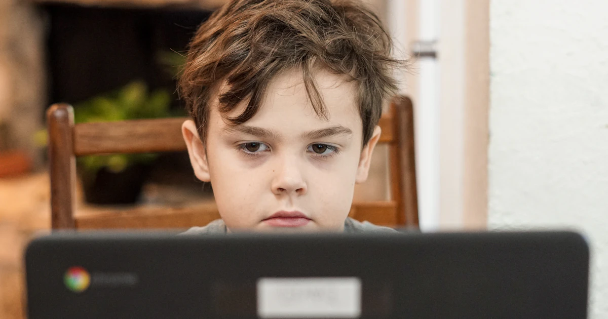 Child using a laptop at home, where parents may want to block websites on Chrome