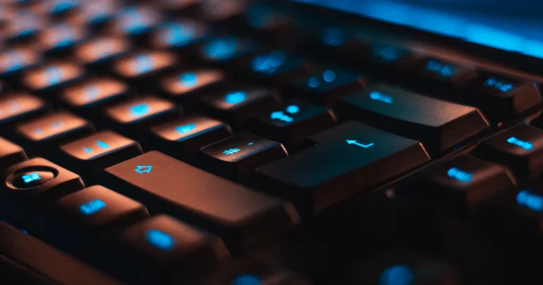 backlit computer keyboard used to type em dash symbols
